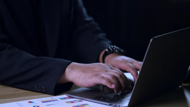 Businessman hands typing on laptop keyboard in slow motion. Businessman working at office with internet. Man searches new job on internet at coffeeshop. Business concept.