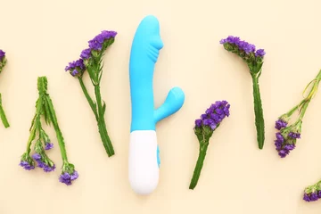 Poster Composition with beautiful lavender flowers and vibrator on beige background © Pixel-Shot