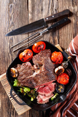 Large piece of grilled meat with vegetables, close-up