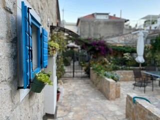Fototapeta na wymiar Beautiful bright blue window shutters on a beautifully preserved old house in a hillside suburb of Split, Croatia