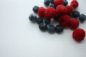 berries of raspberries and blueberries on a white background