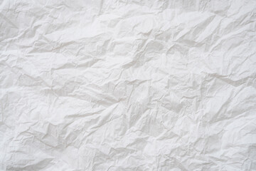 Wrinkled or crumpled white stencil paper or tissue after use in toilet or restroom with large copy space used for background texture in decorative art work.