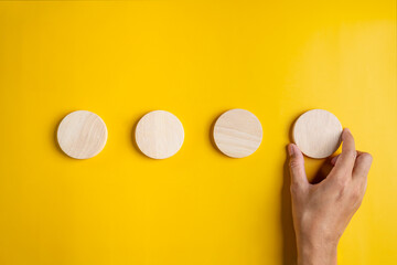 order, wooden, finding, searching, sorting, hand, pointing, orange, background, plan. finding and searching to sorting woodchip circle. behind that background color is orange for make something.