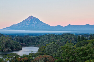 Peaceful scene at dawn over Lake Mangamahoe on New Zealand’s North Island, surrounded by lush...
