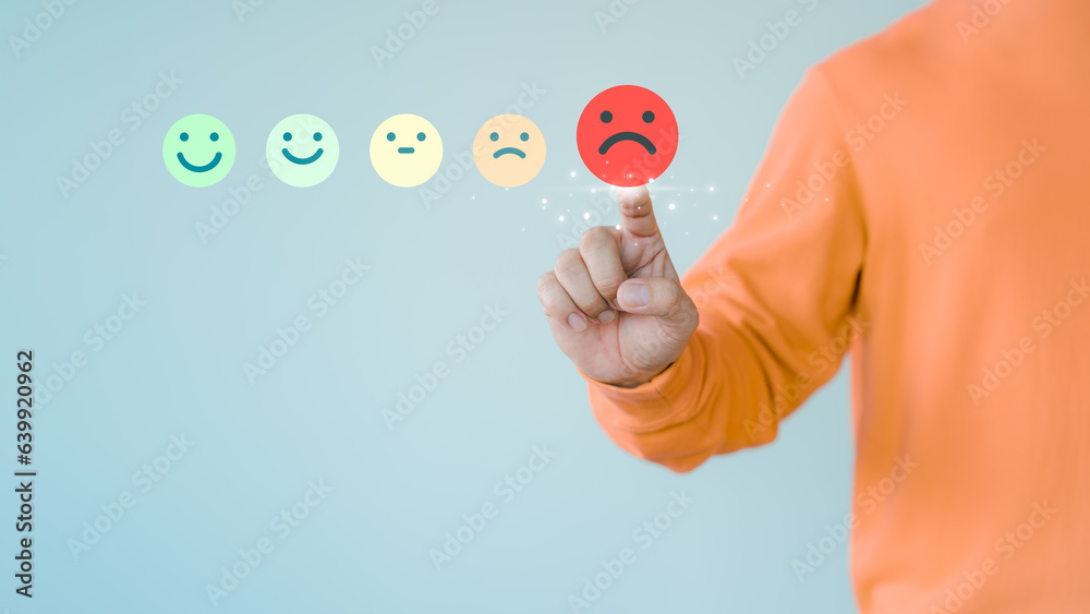 Poster Customer hand touching the virtual screen on the angry emotion face. Assessment testimonial review for dislike service and low quality. Business concept of customer experience dissatisfied.