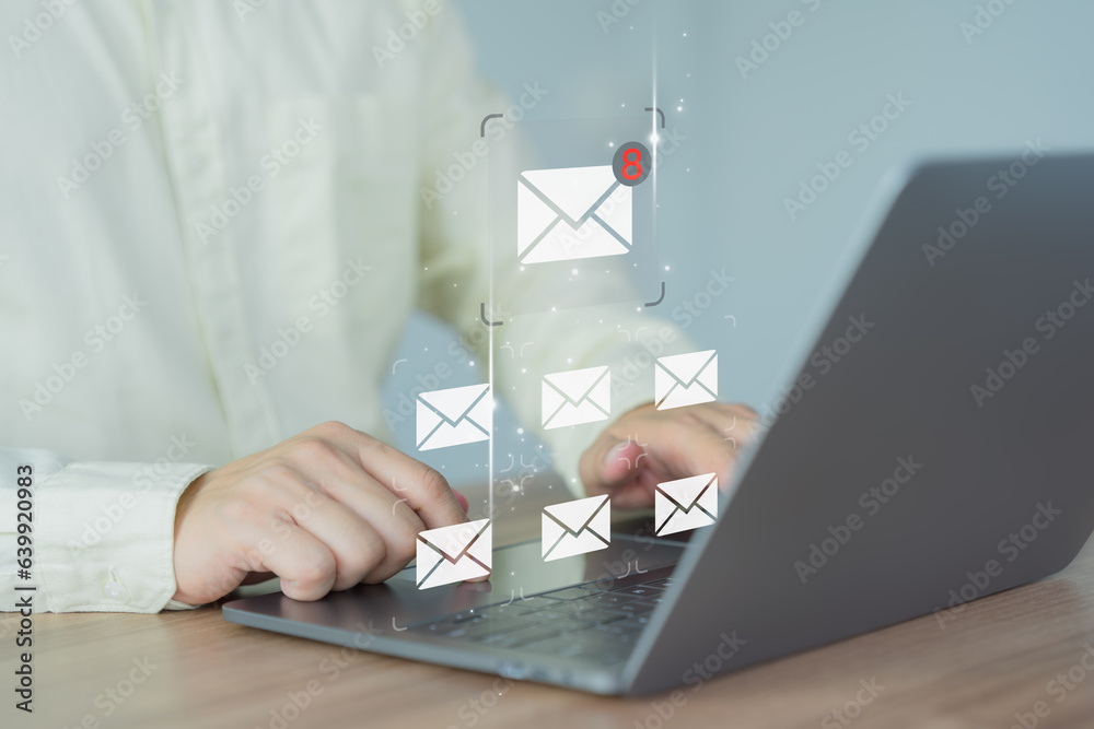 Poster Businessman hand using a computer laptop and sending online message with email icon. Concept of Email from sale and marketing, send email or newsletter, internet network working online.