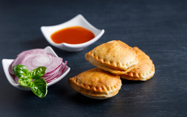 Homemade empanadas with sauces.