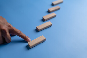 climb, goal, stair, icon, pointing, hand, blue, endeavor, background, attempt. use finger to pointing at stair for climbing hit the goal and mission. background is blue then icon and symbol dont show.