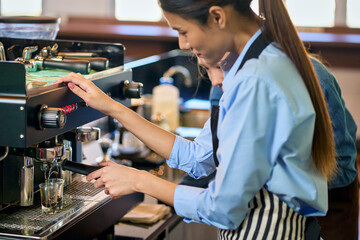 Espresso shot made by coffee machine and Barista girl in coffee cafe shop.