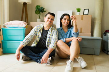 Happy couple getting a mortgage credit and moving in to a new home
