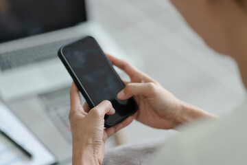 Happy beautiful Asian Woman wearing headphones using laptop at work or enjoying music