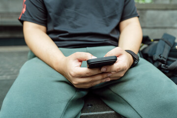 Man playing game on mobile phone. gamer boy playing video games holding Smartphone working mobile devices. cell telephone technology e-commerce concept