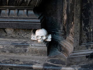 Old sculpted white skull with bones antique architectural detail, closeup. Death symbol, memento...