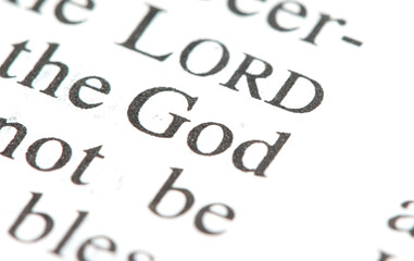 Word "God" on a page in a book, single word macro detail closeup, zoom shot, nobody God, deity, sacrum simple abstract concept, spirituality, religion and faith universal symbol, no people, Holy Bible