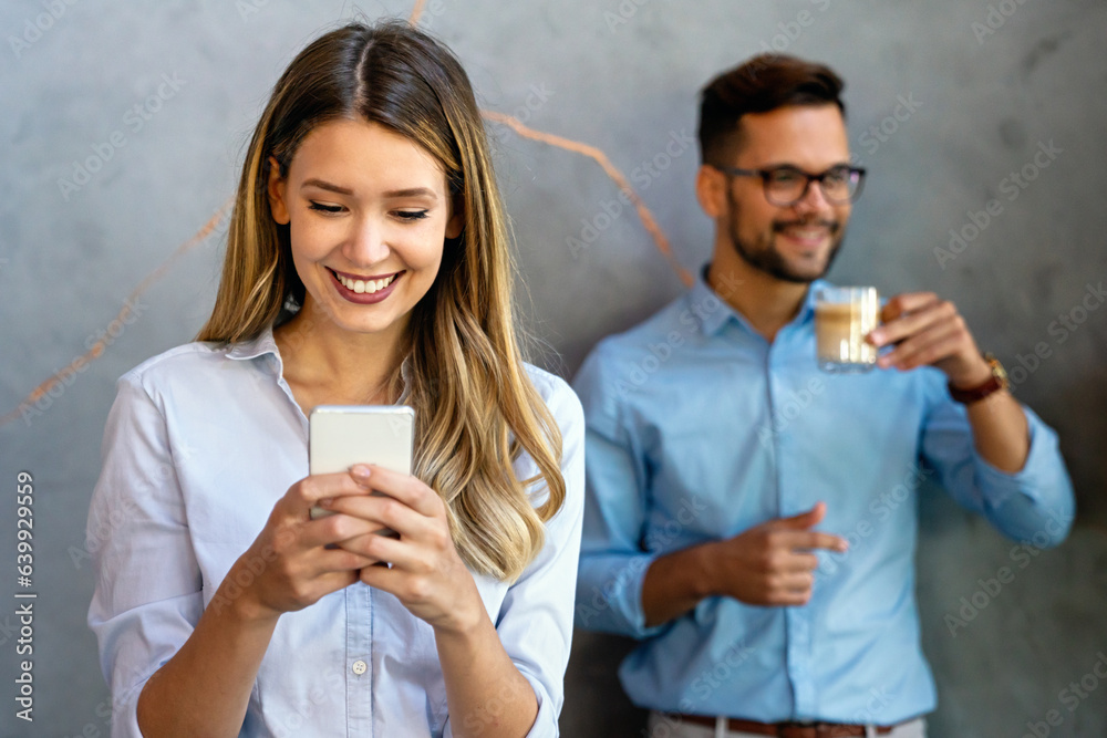 Wall mural Happy businesswoman using mobile phone while analyzing weekly schedule in corporate office