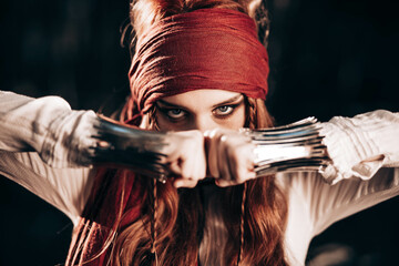 Outdoor portrait of young female in pirate costume.