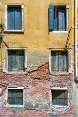 Fototapeta na wymiar Old medieval worn out brick wall building in Venice, Italy.