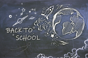 Creative back to school sketch with globe and rocket on blackboard wall backdrop. Education and knowledge concept.