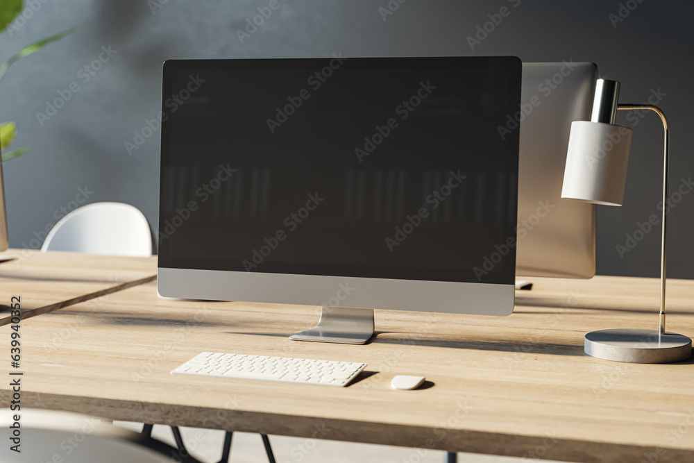 Aufkleber close up of empty computer monitor on wooden office desktop with lamp and supplies. designer workpla