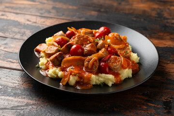 Devilled Sausages with mashed potato, spiced tomato and apple sauce.