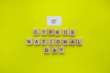 October 1, Independence Day in Cyprus, Cyprus National Day, flag of Cyprus, minimalistic banner with the inscription in wooden letters on a yellow background