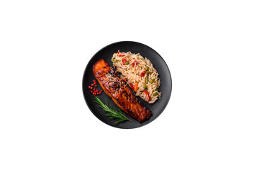 Delicious red salmon fish grilled with sauce and sesame seeds with rice and vegetables