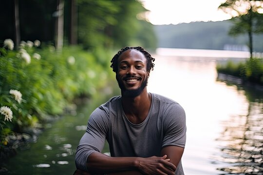 Smiling young black man, having fun and looking at camera near lake. Photo generative AI