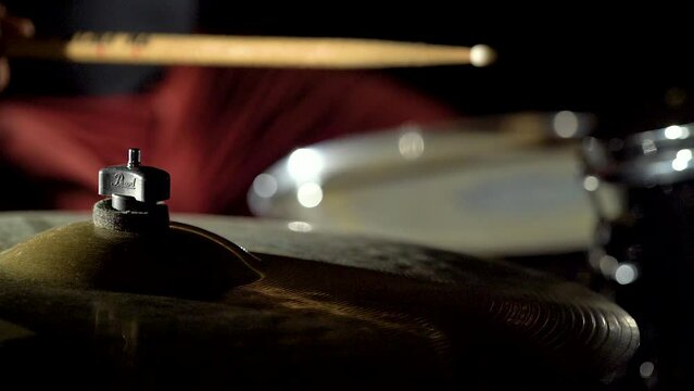 Hands of professional drummer musician is playing hitting drum kit and cymbals