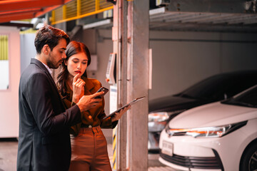 Car salesman talking to male customer