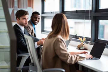 Male mature caucasian ceo businessman leader with diverse coworkers team executive managers group meeting. Multicultural professional businesspeople working together on research plan boardroom.
