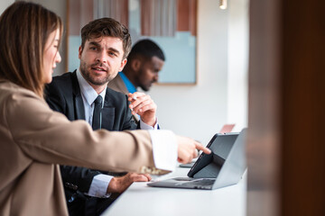 Fototapeta premium Male mature caucasian ceo businessman leader with diverse coworkers team executive managers group meeting. Multicultural professional businesspeople working together on research plan boardroom.