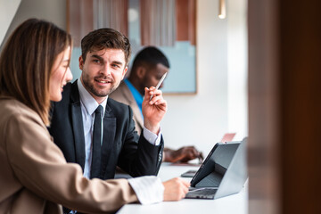 Male mature caucasian ceo businessman leader with diverse coworkers team executive managers group meeting. Multicultural professional businesspeople working together on research plan boardroom.