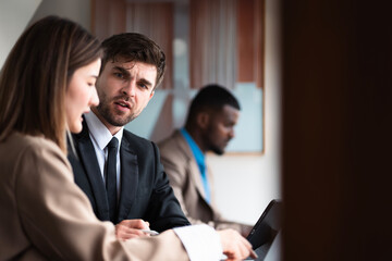 Male mature caucasian ceo businessman leader with diverse coworkers team executive managers group meeting. Multicultural professional businesspeople working together on research plan boardroom.