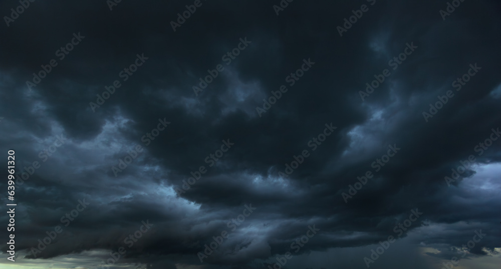 Poster the dark sky with heavy clouds converging and a violent storm before the rain.bad or moody weather s