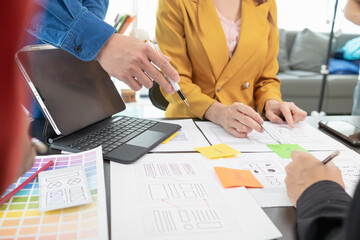 team of UI UX web designer are working together to develop mobile responsive websites with UI UX...