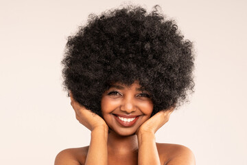 Beauty Portrait of Female Model with Afro Hairstyle. Smiling African Woman with Natural Look and Delicate Makeup.
