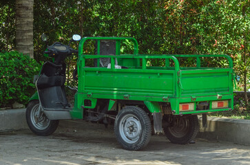 Obraz premium A Modified Motorbike Garbage Cart Parked In The Corner Of The Garden