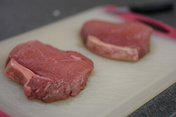 Close up on raw steaks about to be cooked
