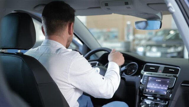 Man touches the touchscreen of car console
