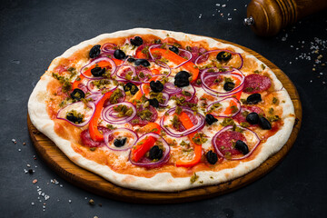 Italian pizza with sausage, cheese, sweet pepper, olives, jalapeno pepper and red onion.