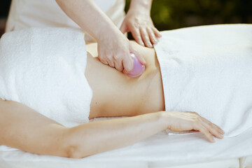 Obraz na płótnie Canvas Massage therapist in spa salon massaging clients stomach