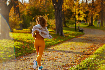female in fitness clothes in park running