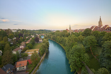 Fototapeta na wymiar View of the Aar river at sunset as it passes through the city of Bern, Switzerland.
