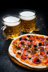 Italian food pizza with sausage, cheese, sweet pepper, olives, jalapeno pepper, red onion on thin dough with beer. - 639978790