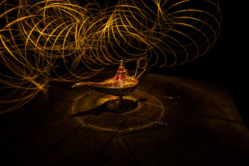 Antique Aladdin arabian nights genie style oil lamp with soft light white smoke, Dark background.