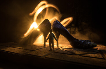Artwork decoration. Silhouette of a high heel women shoes at dark. Women power or women domination...