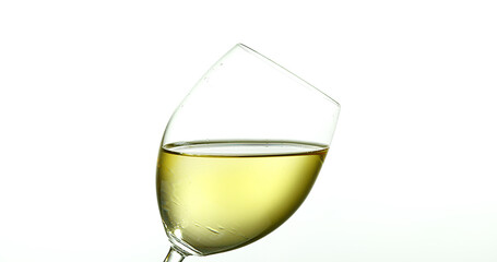 White Wine being poured into Glass, against White Background