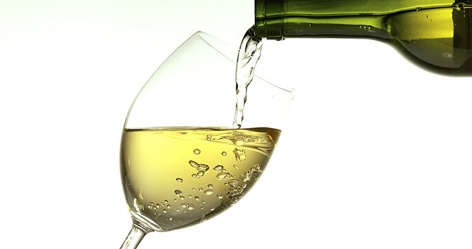 White Wine being poured into Glass, against White Background