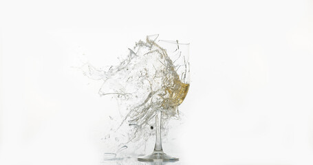 Glass of White Wine Breaking and Splashing against White Background
