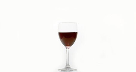 Red Wine being poured into Glass, against White Background